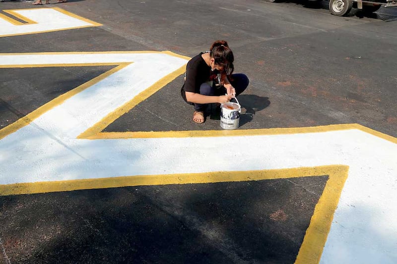 A street message receives some detail work. (RFA)