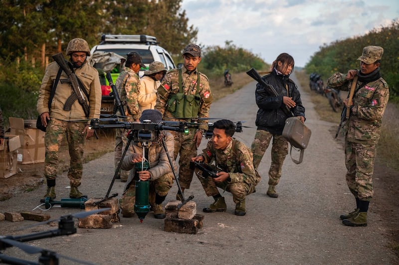 Fighters of anti-junta Mandalay People's Defense Forces prepare a drone with an explosive-drop amid clashes with Myanmar junta forces in northern Shan State, Dec. 11, 2023.