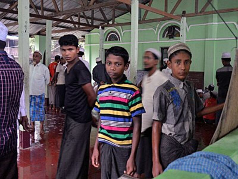 Rohingya Muslim men and boys arrive for Friday prayers at a camp in Sittwe, western Myanmar's Rakhine state, June 10, 2016.