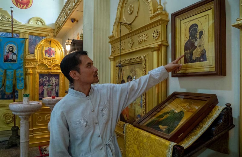 Father Danai Wanna, the first Thai national ordained as a Russian Orthodox priest, points to an icon in the Church of All Saints on the outskirts of Pattaya, June 22, 2023. Credit: Tran Viet Duc/RFA