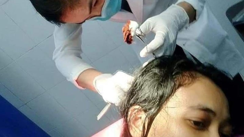 Eang Maryna receiving treatment for the head wound she suffered during an assault, May 11, 2020.