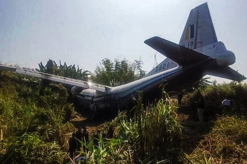 Indian security personnel inspect a Myanmar army plane after it skidded off the runway at Lengpui Airport in India's northeastern state of Mizoram, Jan. 23, 2024. The plane was landing to collect soldiers and repatriate them to Myanmar. (Mizoram State Government/AFP)