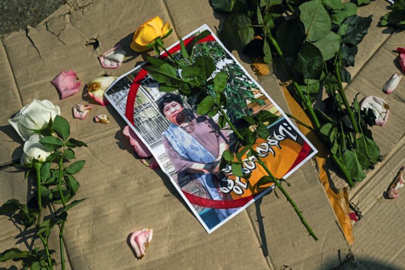 Flowers are placed on a photo of teacher Tin Nwe Yi, who was killed in a demonstration against the military coup, during a memorial ceremony in Yangon, Myanmar, March 1, 2021. AFP