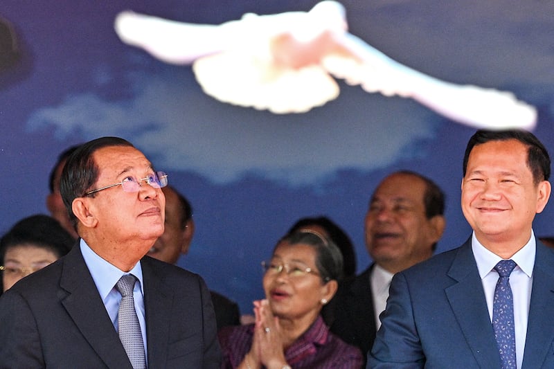 Cambodia's Senate President Hun Sen, left, and Cambodia's Prime Minister Hun Manet release doves during a ceremony marking the 46th anniversary of the fall of the Khmer Rouge regime in Phnom Penh, Jan. 7, 2025.