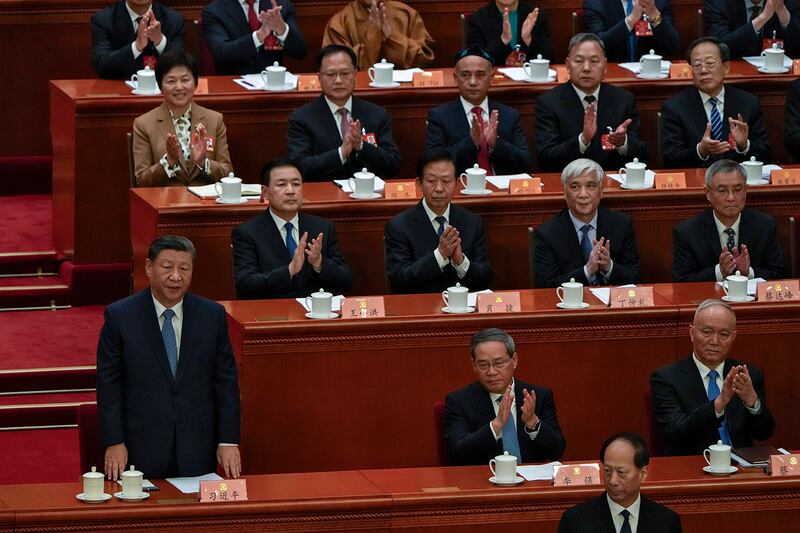 Delegates applaud as Chinese President Xi Jinping stands during the opening session of the Chinese People's Political Consultative Conference in Beijing, March 4, 2025.