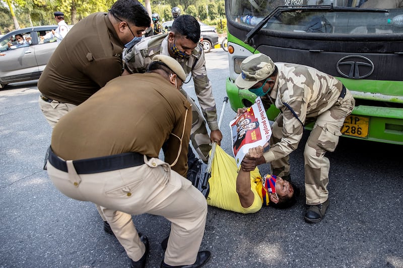 Police officers detain a Tibetan during a protest held to mark the 62nd anniversary of the Tibetan uprising against Chinese rule, outside the Chinese Embassy in New Delhi, India March 10, 2021.