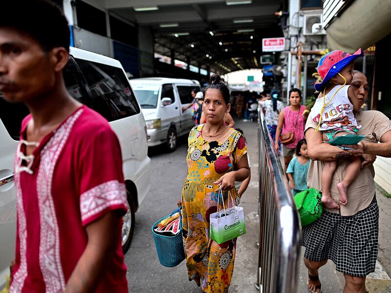 Myanmar nationals cross over into Thailand at the Tak border checkpoint in Thailand's Mae Sot district on April 10, 2024.