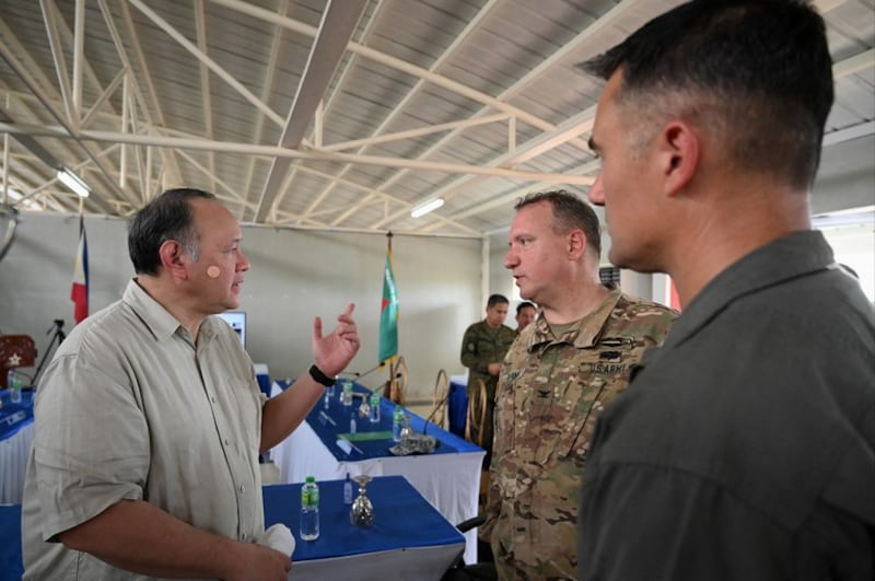 Philippine Defense Secretary Gilbert Teodoro (left) talks with Col. Edward Evans, chief of the Joint U.S. Military Advisory Group, at Lal-lo Airport in Cagayan province, northern Philippines, Aug. 3, 2023. Credit: Jam Sta Rosa/AFP/pool