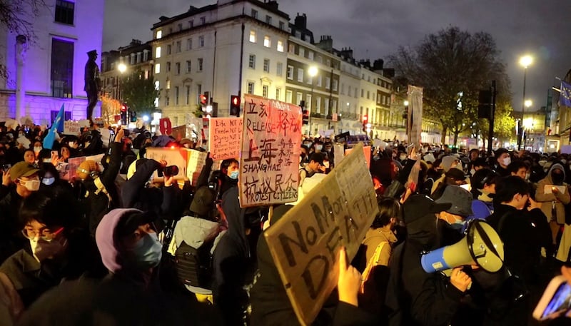 People protest against China's coronavirus disease (COVID-19) curbs in front of the Chinese embassy in London, Britain November 27, 2022 in this still image from a social media video. Alexander Mak/via REUTERS