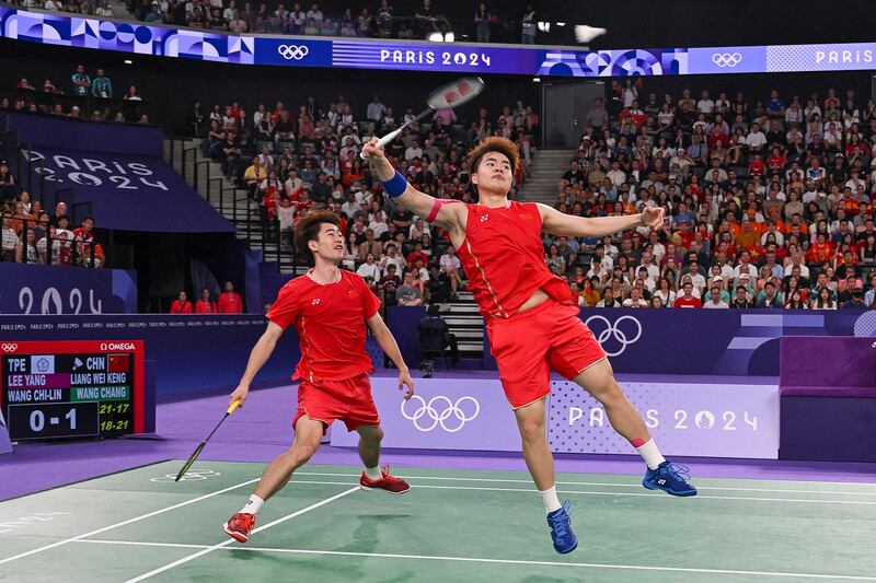 Liang Weikeng (left) and Wang Chang (right) of China in the men's doubles badminton final at the Paris Olympics. (Reuters)