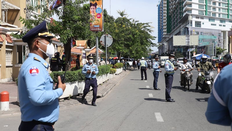 Police guard the streets in front of Cambodia's Phnom Penh Municipal Court, Nov. 26, 2020.