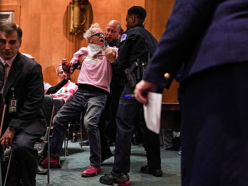 Security personnel remove a protester as Sen. Marco Rubio testifies before a Senate Foreign Relations Committee hearing on his nomination to be Secretary of State, in Washington, Jan. 15, 2025.