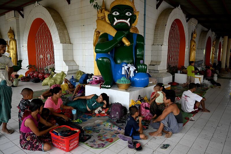 People shelter at a monastery in Sittwe town in Myanmar's Rakhine state on Friday, May 12, 2023. Credit: AFP