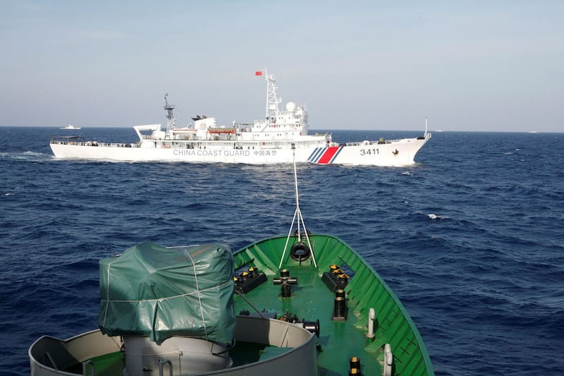 A file photo of a ship (top) of the Chinese Coast Guard is seen near a ship of the Vietnam Marine Guard in the South China Sea, about 210 kilometers (130 miles) off shore of Vietnam May 14, 2014. 