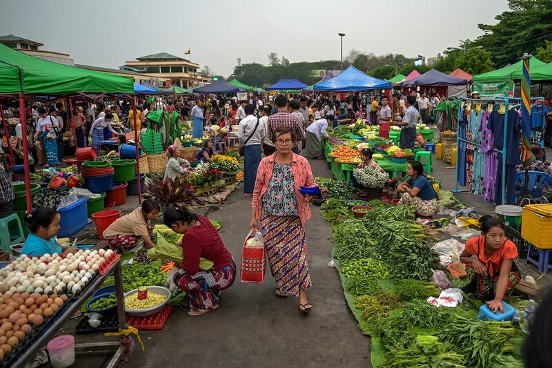 A woman walks through the Myo Ma market in Naypyidaw on March 26, 2024. (AFP)