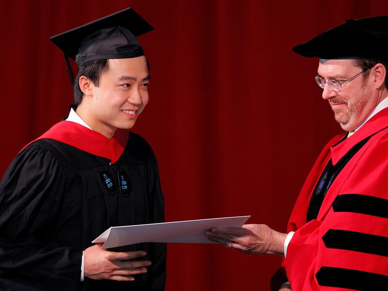 Bo Guagua, son of fallen Chinese politician Bo Xilai, receives his masters degree in public policy from Senior Lecturer John Donohue, right, at Harvard University in Cambridge, Massachusetts May 24, 2012.  (Reuters/Brian Snyder)