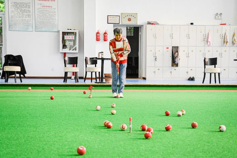 An elderly woman plays gateball at a university in Rudong, in eastern Chinaís Jiangsu province, April 27, 2023. (Jade Gao/AFP)