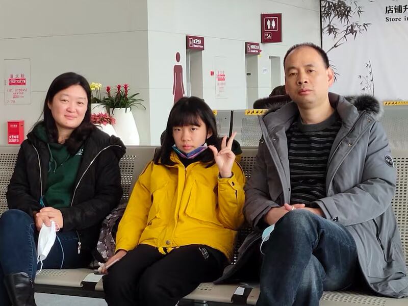 Detained rights lawyer Lu Siwei, right, with his family before his wife and daughter left for the United States, undated photo.