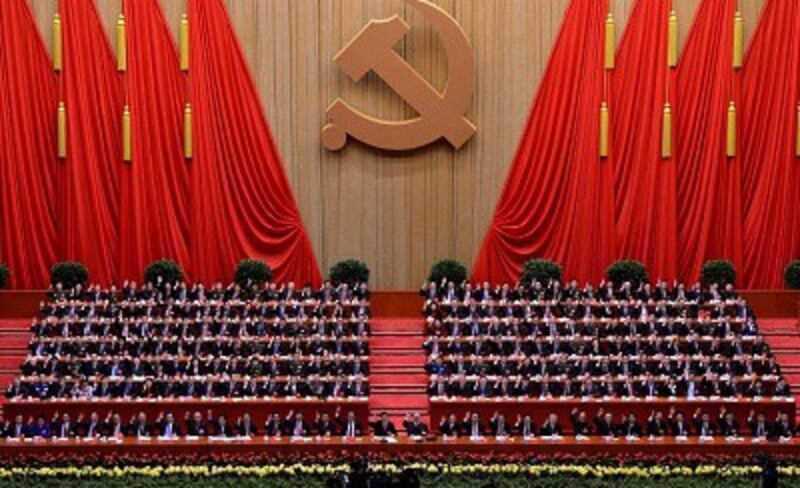 Chinese Communist Party leaders wave at the closing ceremony of the 18th Party Congress in Beijing, Nov. 14, 2012.