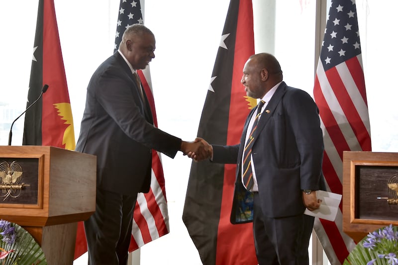 Papua New Guinea's Prime Minister James Marape shakes hands with US Secretary of Defense Lloyd Austin in Port Moresby, July 27, 2023.