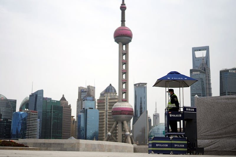 A police officer on guard in Shanghai's Lujiazui financial district, March 28, 2022. Credit: Reuters