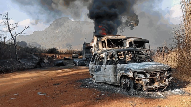 Burned vehicles sit on a dirt road in Hpruso township following clashes between the Karenni Nationalities Defense Force and junta soldiers in eastern Myanmar's Kayah state, Dec. 25, 2021. Credit: Handout/Karenni Nationalisities Defense Force/AFP