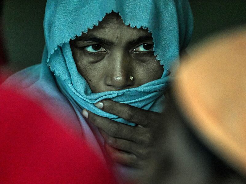 A Rohingya refugee looks to members of the United Nations High Commissioner for Refugees while they meet at a temporary shelter at a government building in Banda Aceh, Indonesia, April 22, 2024.