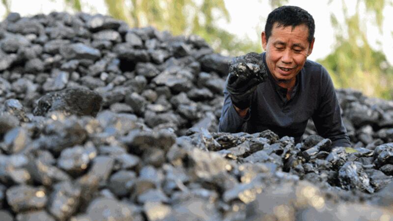 A man works in a coal yard in Hanoi, Vietnam, Nov. 9, 2021. Credit: AFP