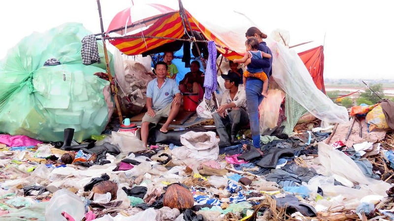 A Cambodian family living in a shelter on a garbage dump in a Phnom Penh suburb in 2015.