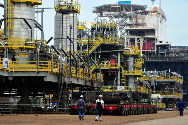 Chinese workers walk along an offshore oil engineering platform in Qingdao, eastern China's Shandong province, June 1, 2016.  