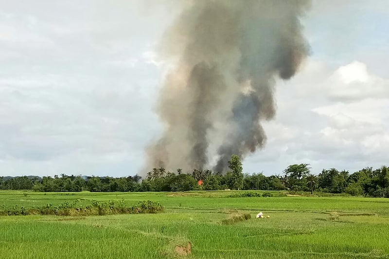 Smoke rises from what is believed to be a burning village in the area near Maungdaw in Myanmar's Rakhine state, Aug. 30, 2017. Credit: AFP