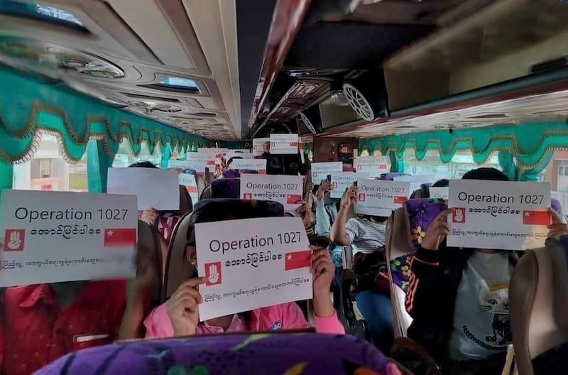 Passengers in a bus display posters in support of the military operation of Myanmar National Democratic Alliance Army. Credit: Citizen journalist