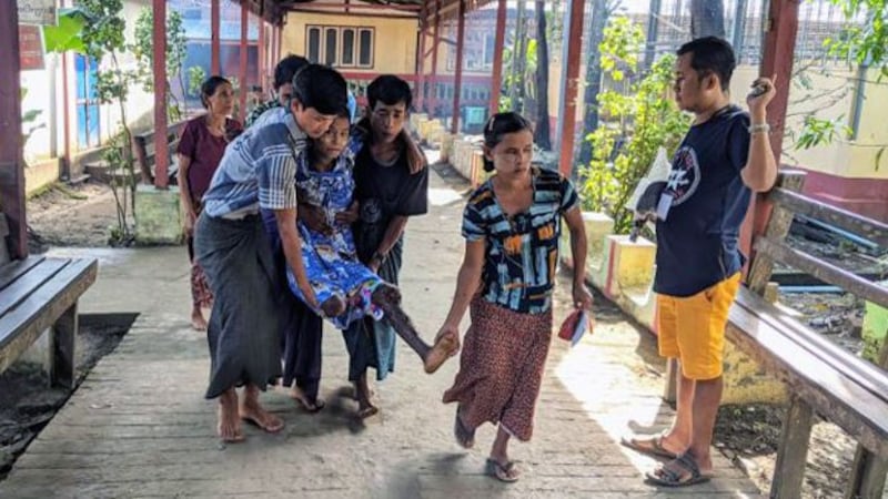 Villagers carry a child injured by a landmine explosion in Ponnygyun township, western Myanmar's Rakhine state, as he is being transported to Sittwe General Hospital for medical treatment, Nov. 3, 2020.