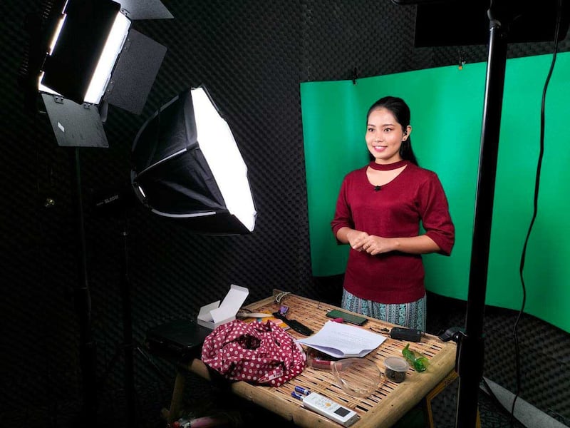 Every day, Htet Htet Eaindra Aung records a news segment in front of a greenscreen for the online-only news outlets of PVTV and Delta News.