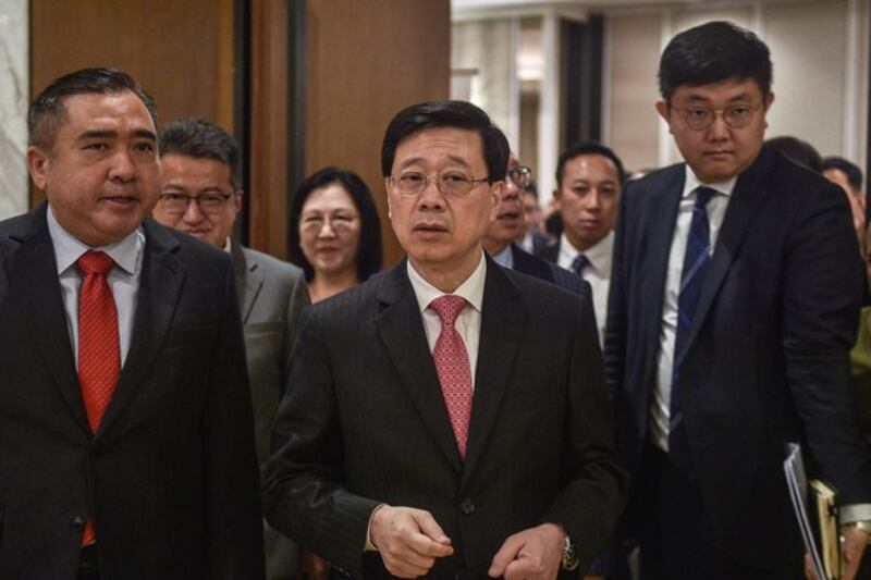 Hong Kong's Chief Executive John Lee (C) arrives for the 'Malaysia-Hong Kong Partnering for Success' ceremony in Kuala Lumpur, July 28, 2023. Lee says the new legislation will extend the reach of current laws and guard against 'covert rebellions' and 'soft resistance.' Credit: Arif Kartono/AFP