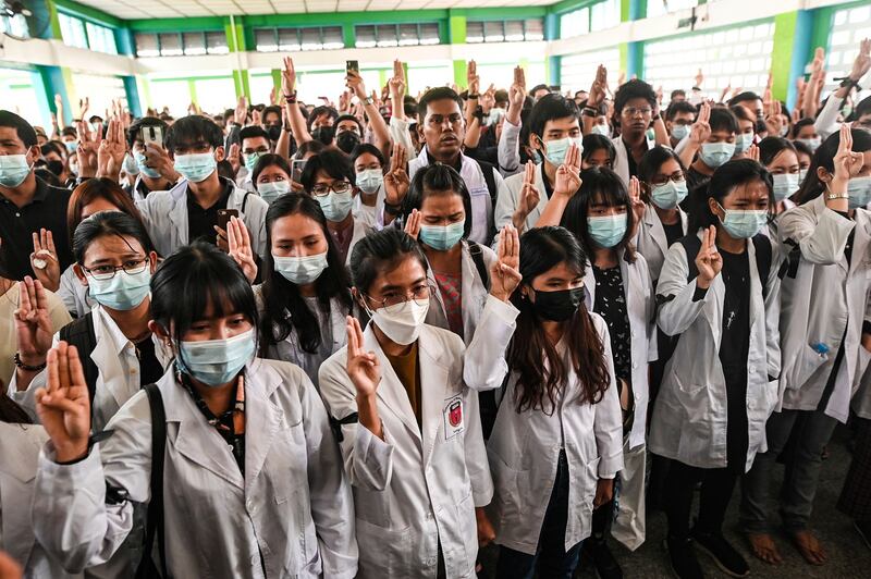 Medical students show the three-finger salute at the march 16, 2021, funeral of Khant Nyar Hein, a 17-year-old medical student shot and killed by junta security forces in Yangon, Myanmar. Credit: Reuters