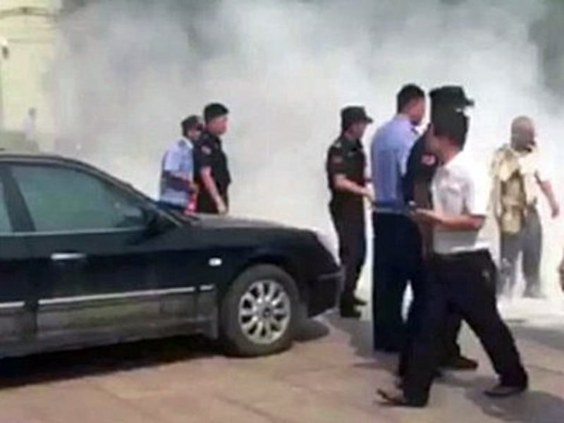 Smoke rises from the scene where a Chinese man set himself ablaze to protest the education system in Beijing, May 20, 2016.