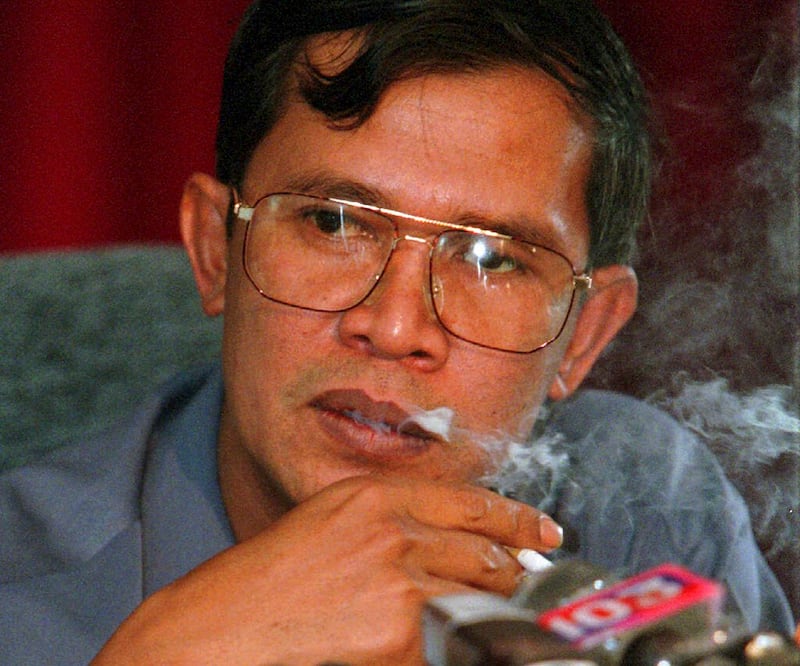 In this April 19, 1997 file photo, then Cambodian Second Prime Minister Hun Sen smokes a cigarette during a news conference held in his compound at Takhamao, south of Phnom Penh, Cambodia. (AP Photo/Charles Dharapak)