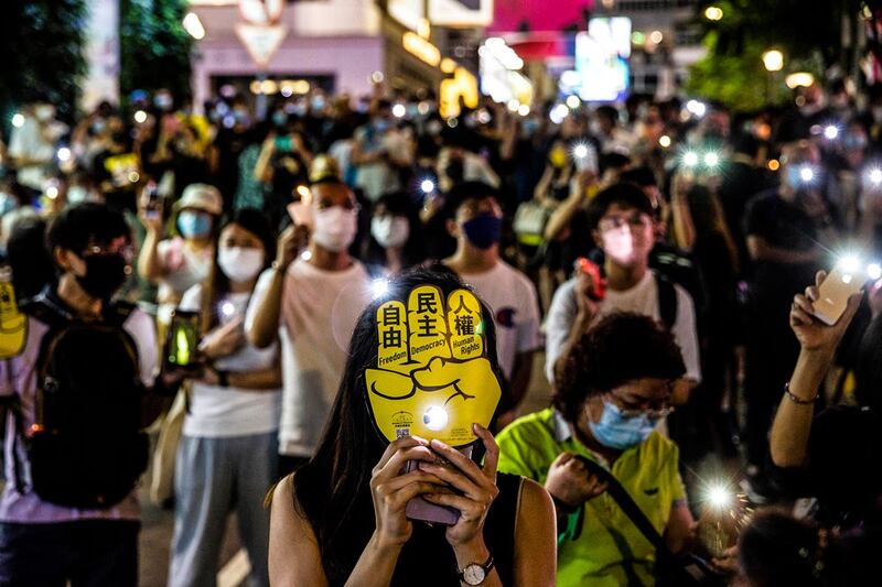 People mark the Tiananmen Square anniversary in the Causeway Bay district. (AFP)