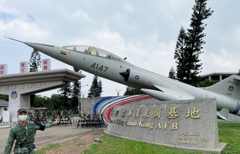 A soldier gestures at the main gate of Ching Chuan Kang Air Base, which is decorated with a retired F-104 fighter jet, in Taichung, Taiwan, Sep. 2, 2021. Yimou Lee/Reuters