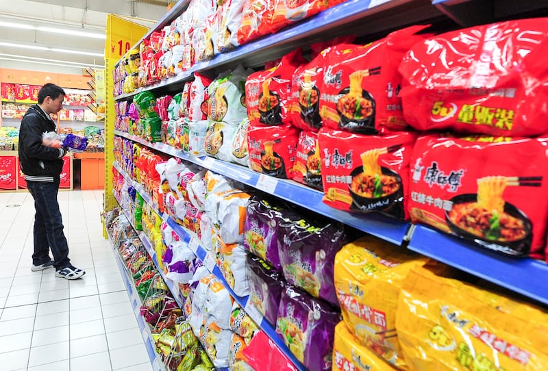 A man shops for instant noodles at a supermarket in Beijing, April 6, 2011. (Frederic J. Brown/AFP)