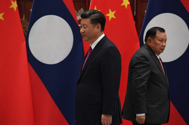 In this Sept. 2, 2016 photo Chinese President Xi Jinping, left and General Secretary of the Lao People's Revolutionary Party Bounnhang Vorachith, right during their meeting at the West Lake State Guest House in Hangzhou, Zhejiang Province, China. Credit: Iwasaki Minoru/Pool/AFP