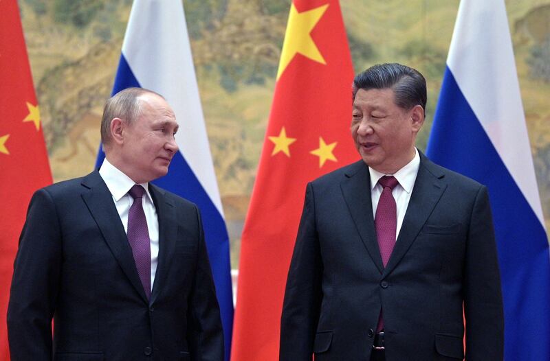 Russian President Vladimir Putin (L) and Chinese President Xi Jinping pose for a photograph during their meeting in Beijing, Feb. 4, 2022. AFP