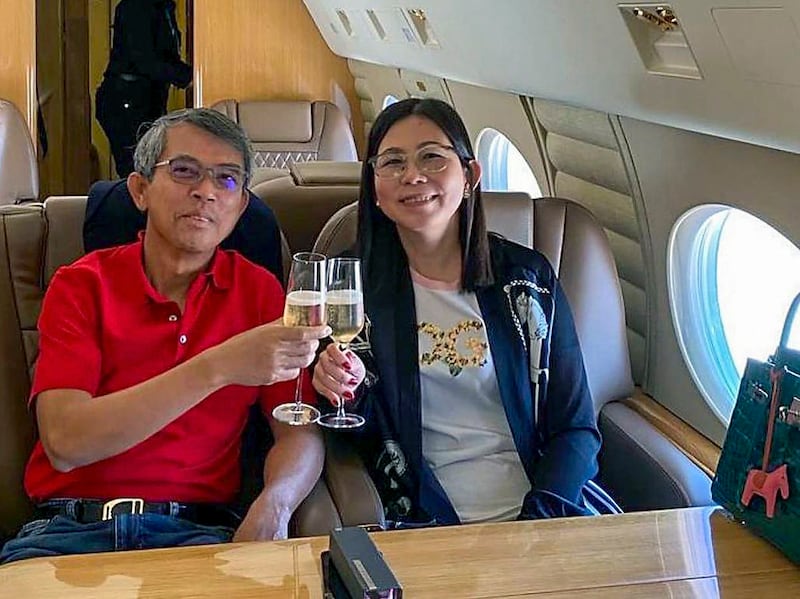 Ing Bun Hoaw, former Cambodian secretary of state for transport, left, and his wife Heng Sokha. aboard a charter jet at an undisclosed location, June 20, 2021.