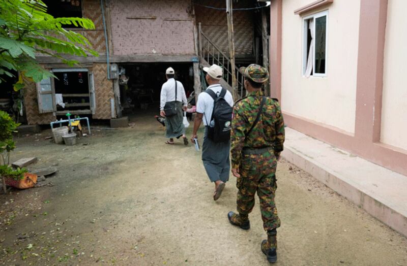 A soldier provides security to census takers who collect information in Myanmar's capital Naypyitaw as the country holds a national census to compile voter lists for a general election, Oct. 1, 2024. (Aung Shine Oo/AP)