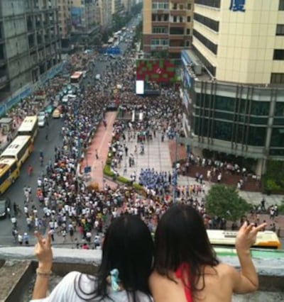 A photo submitted by a netizen shows two women looking down on a rally held by the "Support Cantonese" movement in Guangzhou.