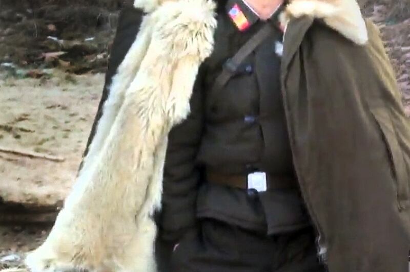 A North Korean soldier wears a dog fur coat along the Yalu River in 2014.