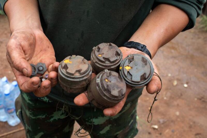 A member of the anti-junta Karenni Nationalities Defense Force holds landmines planted by the Myanmar military and removed during demining operations near Pekon township in Myanmar's southern Shan state, July 11, 2023. (AFP)