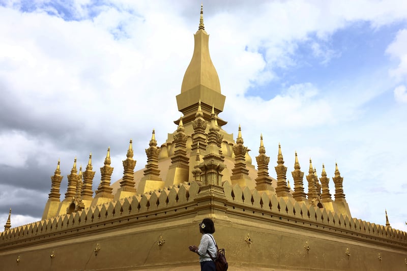 A woman prays as she walks around Pha That Luang stupa, in Vientiane, Laos, July 28, 2024.