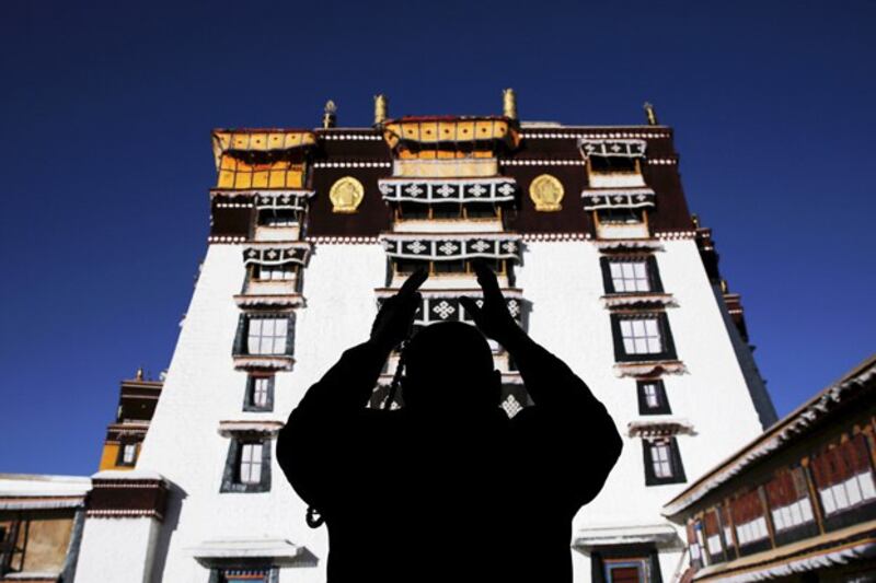 A Tibetan prays at Potala Palace in Lhasa, capital of western's China's Tibet Autonomous Region, Nov. 17, 2015. The Potala Palace, once the seat of Tibetan government and traditional residence of Dalai Lama, is a 13-story palace with more than 1,000 rooms. (Damir Sagolj/Reuters)